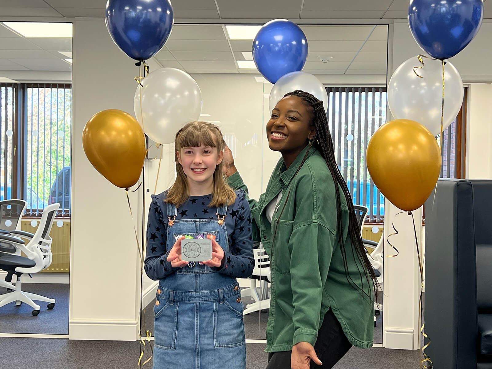 Bethany and Blue Peter presenter Mwaksy Mudenda with her winning design plaque, created by Steve Neaves at Crux Design Agency for the Awesome Orbit Competition.