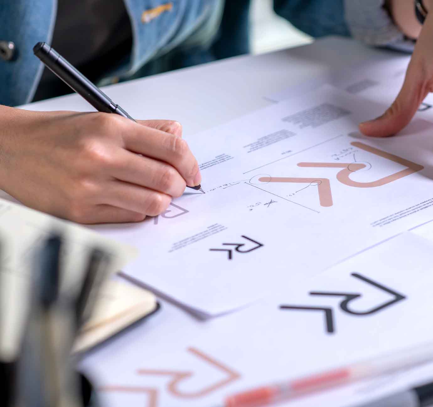 A designer at Crux Design Agency creating a brand identity as part of their logo design service offering